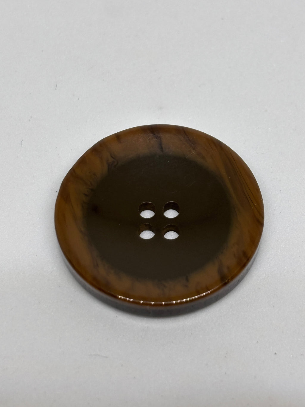 Button P5555 - 25mm (40") polyester button in dark brown with four holes, perfect for sewing and crafting. boton