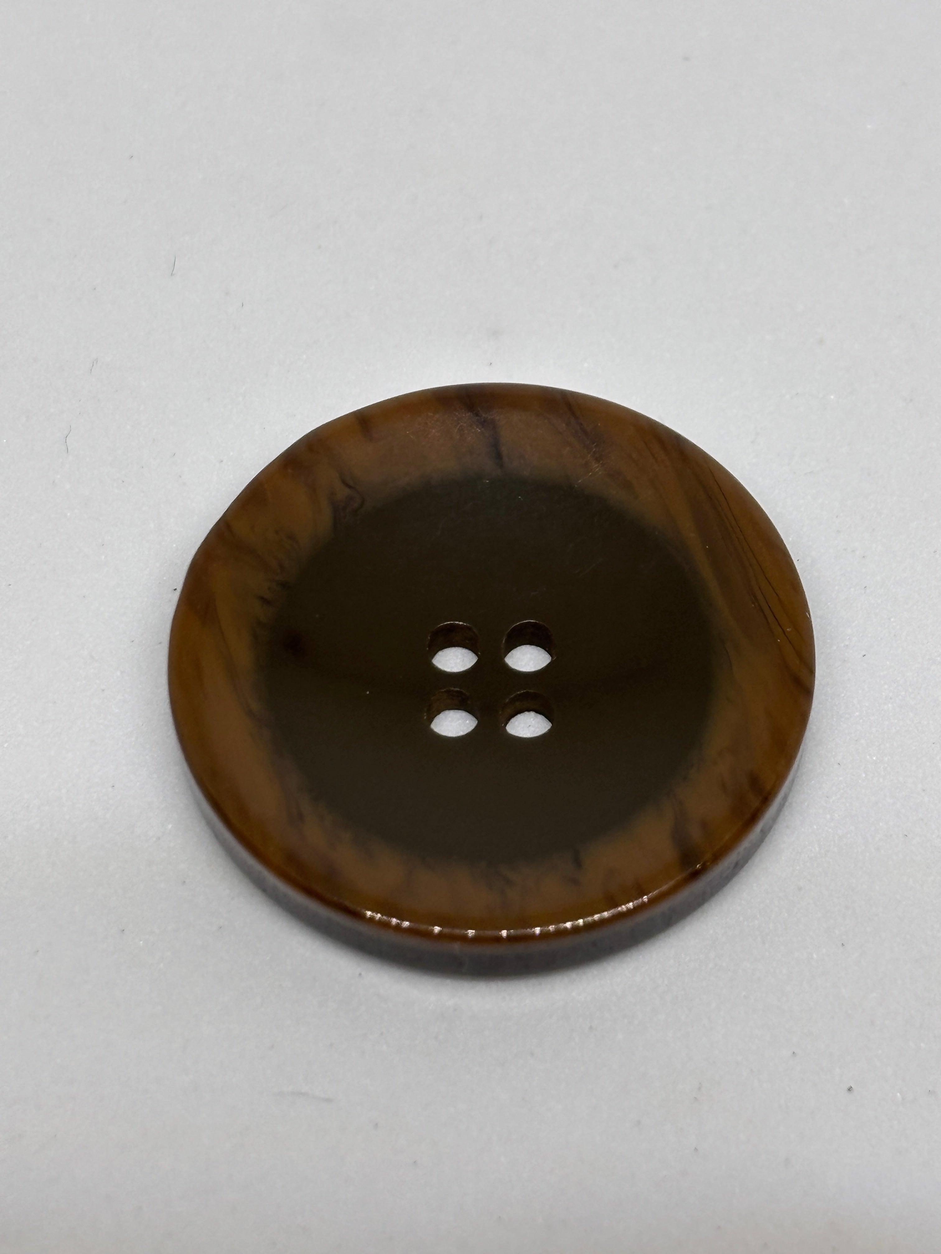 Button P5555 - 25mm (40") polyester button in dark brown with four holes, perfect for sewing and crafting. boton