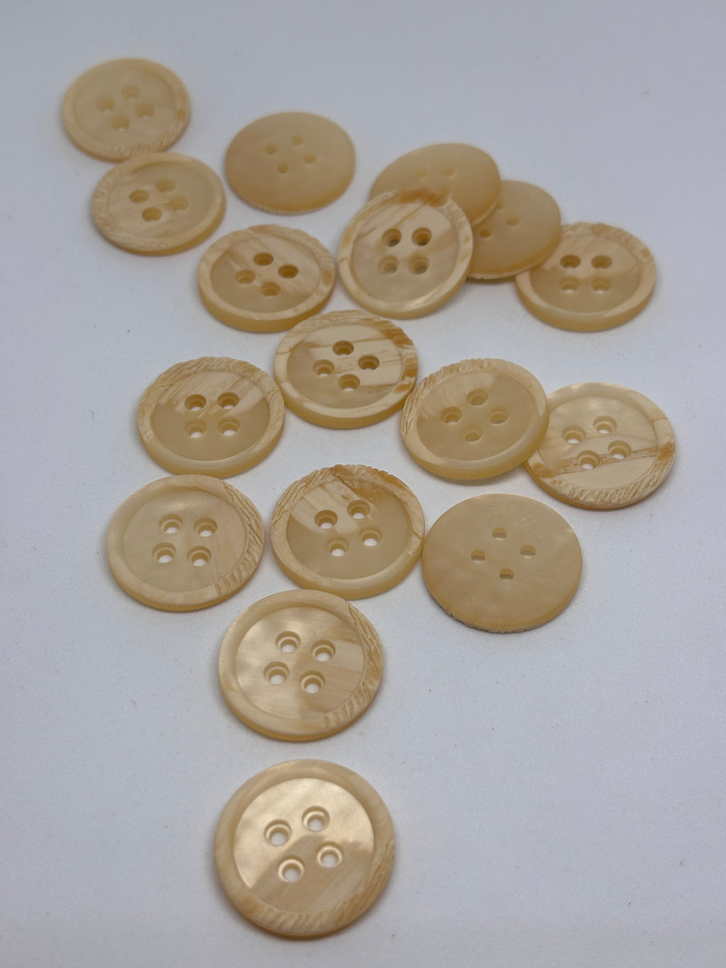 Polyester button P54299 - 36" in off-white color, featuring four holes for sewing and crafting. Boton